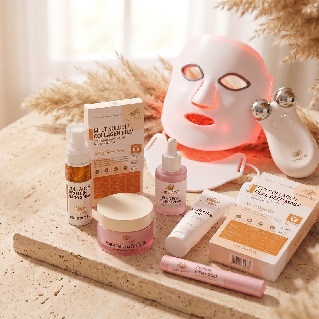 The Complete Glow Set — every LumaNYC product on a travertine counter